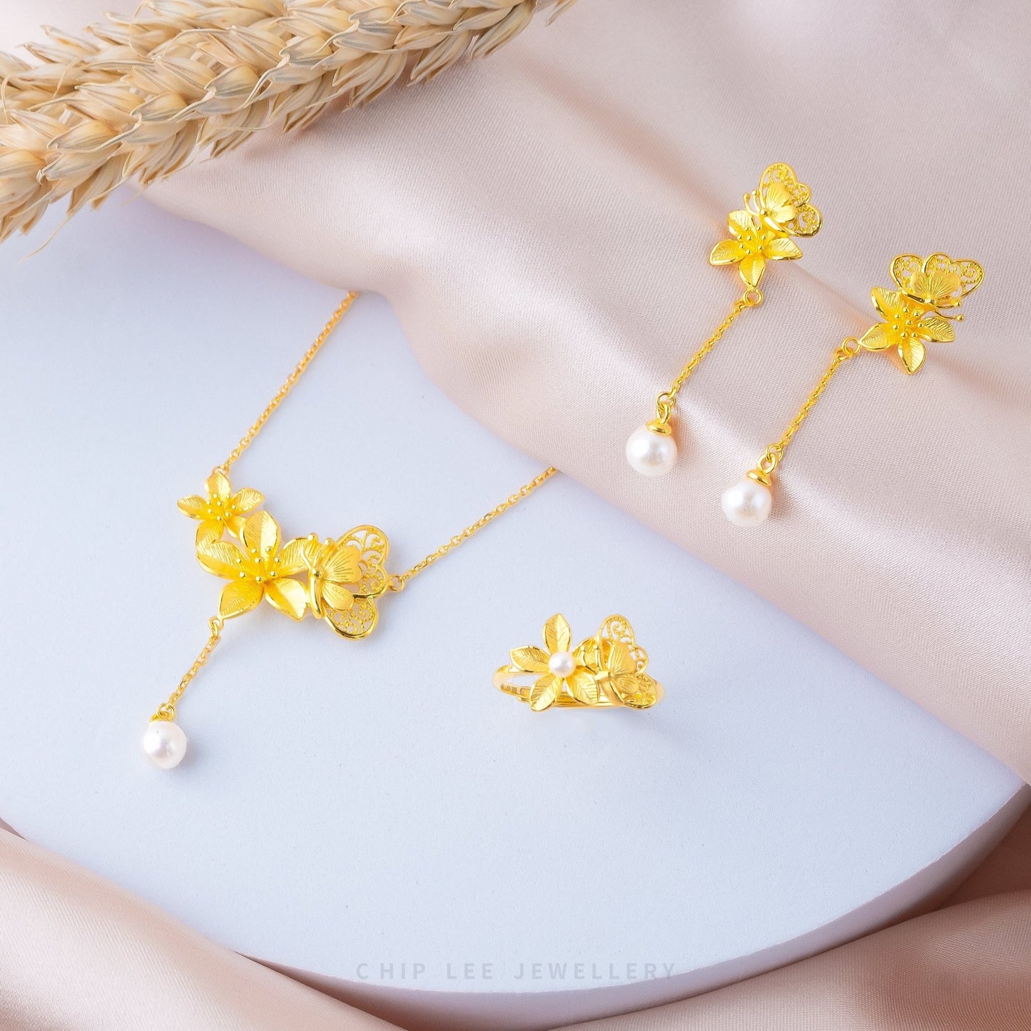 999 Pure Gold Butterfly Pearl Earrings with floral motifs and a pearl accent, crafted in solid gold for timeless elegance and feminine charm.