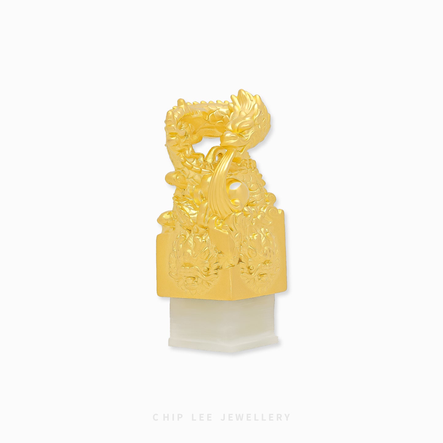 999 pure gold dragon pendant embracing He Tian jade seal, symbolizing power, fortune, protection in a refined traditional jewellery design.