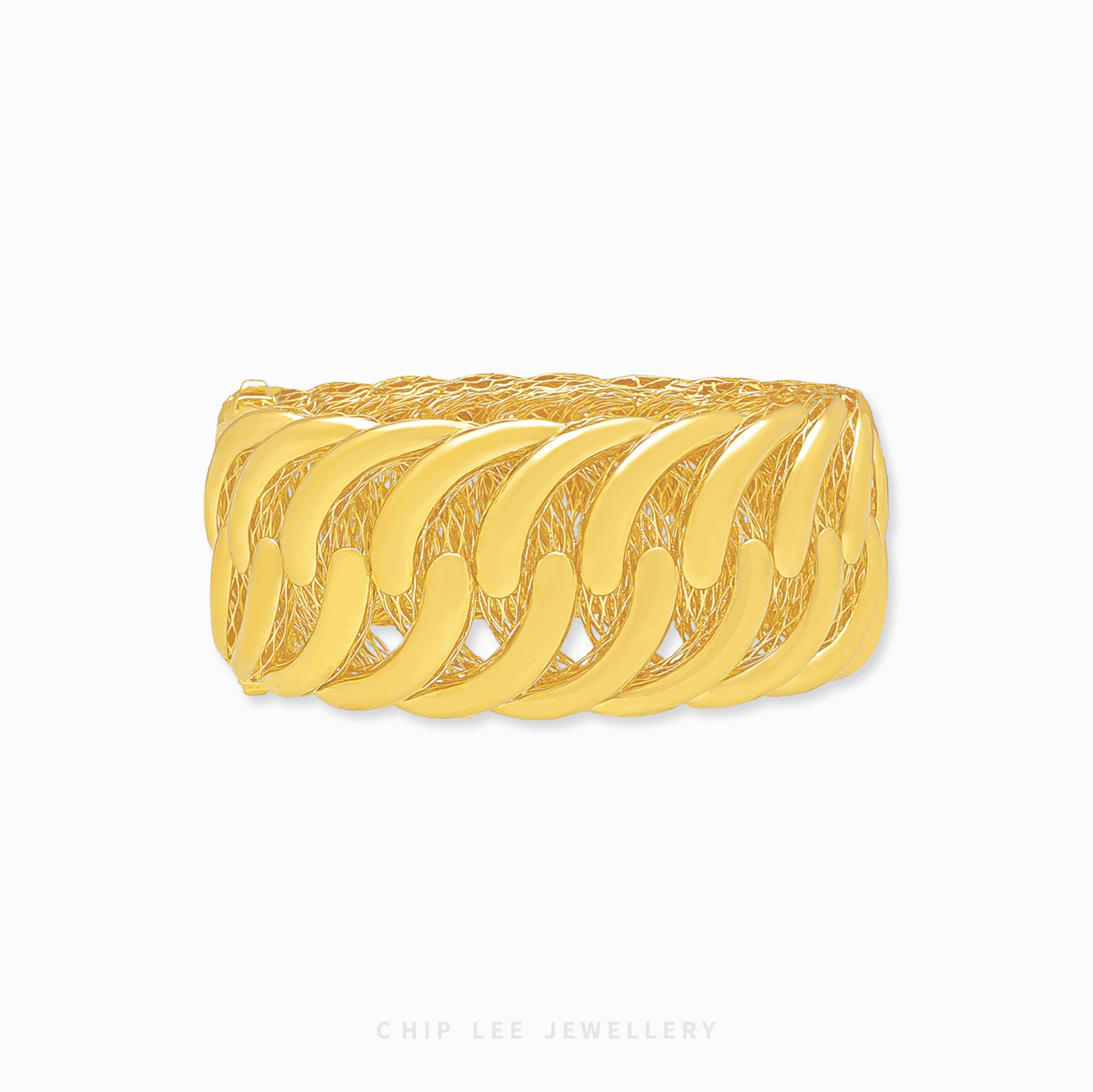 Gold bangle with intricate design on a white background