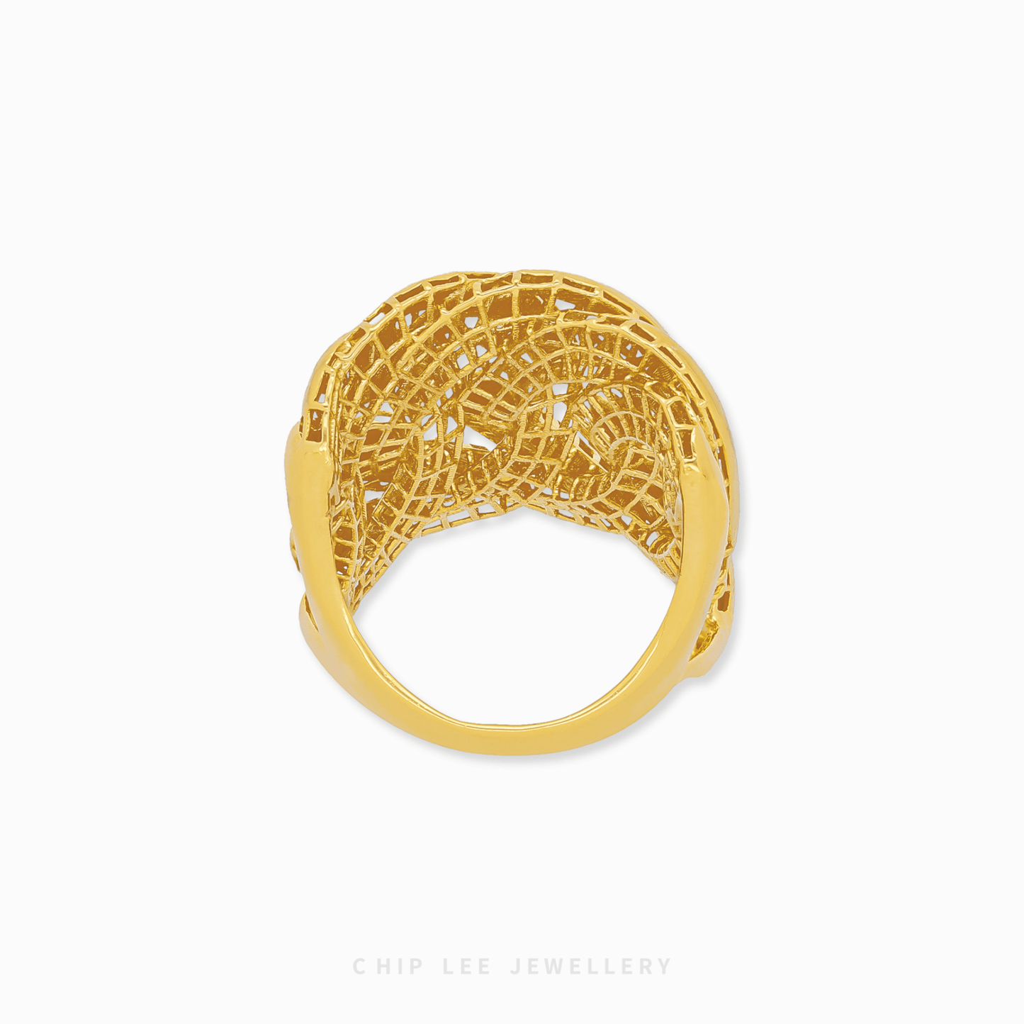 Gold ring with intricate design on a white background