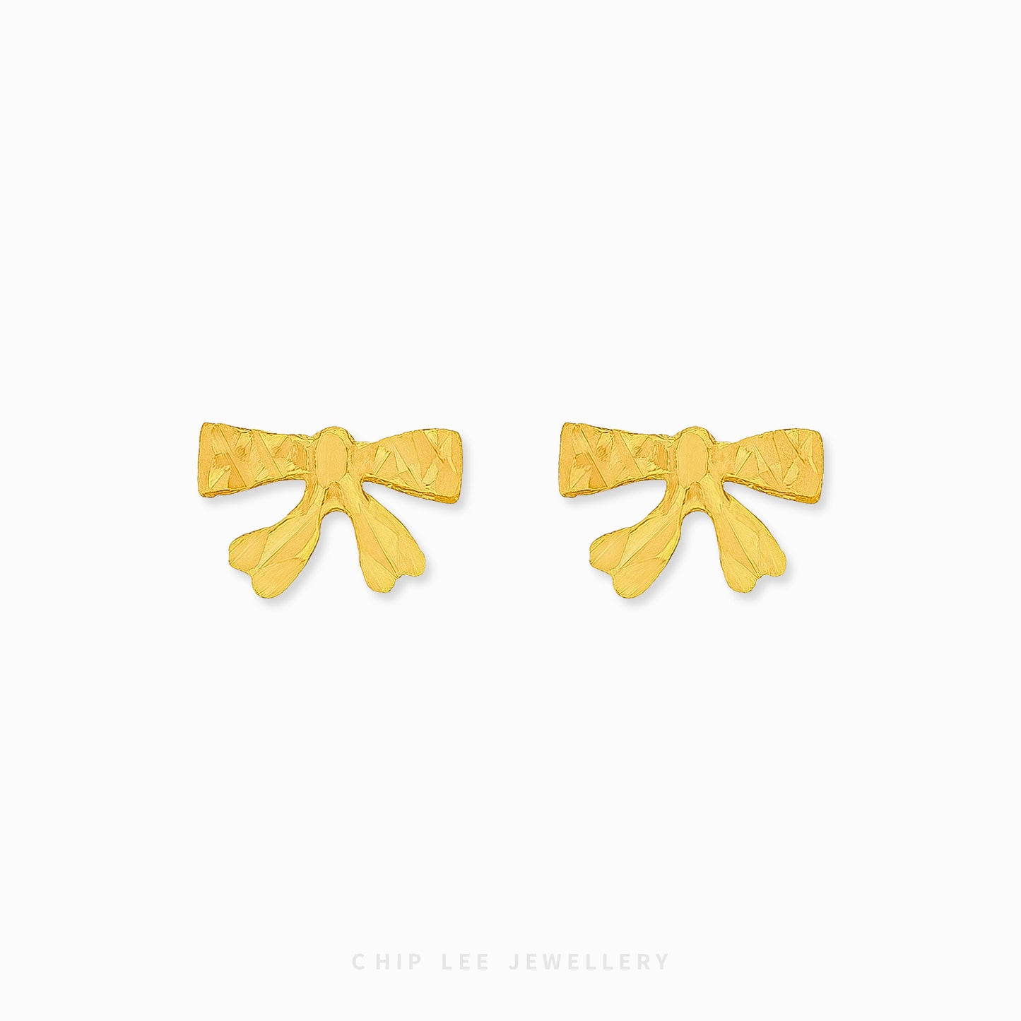 Chip Lee Jewellery Dainty Ribbon Studs. 916 Gold (22K) ribbon-shaped stud earrings. Lightweight, certified pure gold Singapore jewelry.