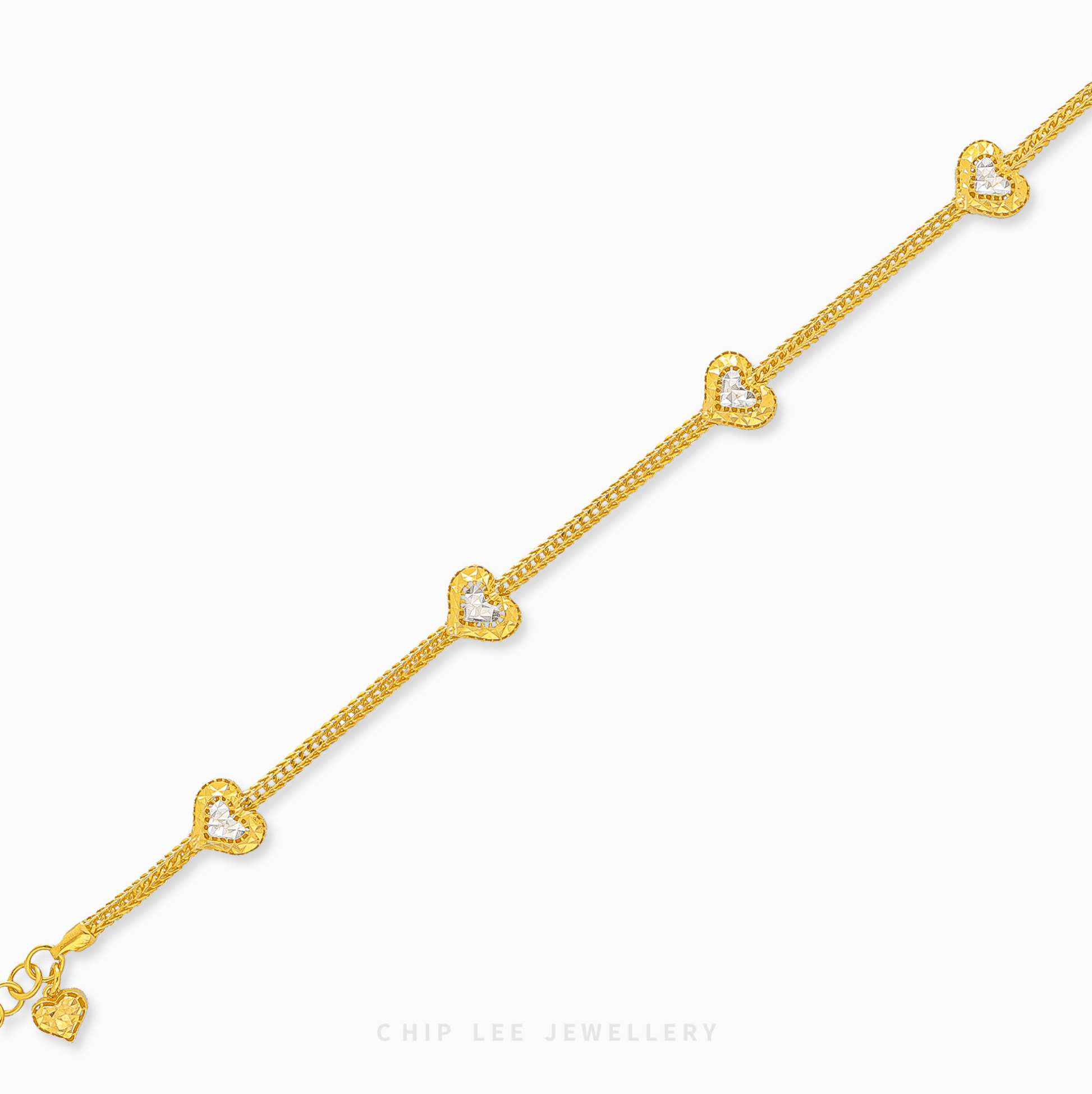 Duo Tone Heart Charm Bracelet in 916 gold. Subtle, symbolic heart design perfect for stacking or a timeless statement.