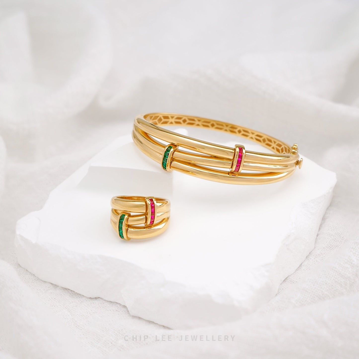 Bold 916 gold bangle and ring set featuring ruby and emerald tone cubic zirconia design. Hallmarked by Singapore Assay Office for certified purity and authenticity.
