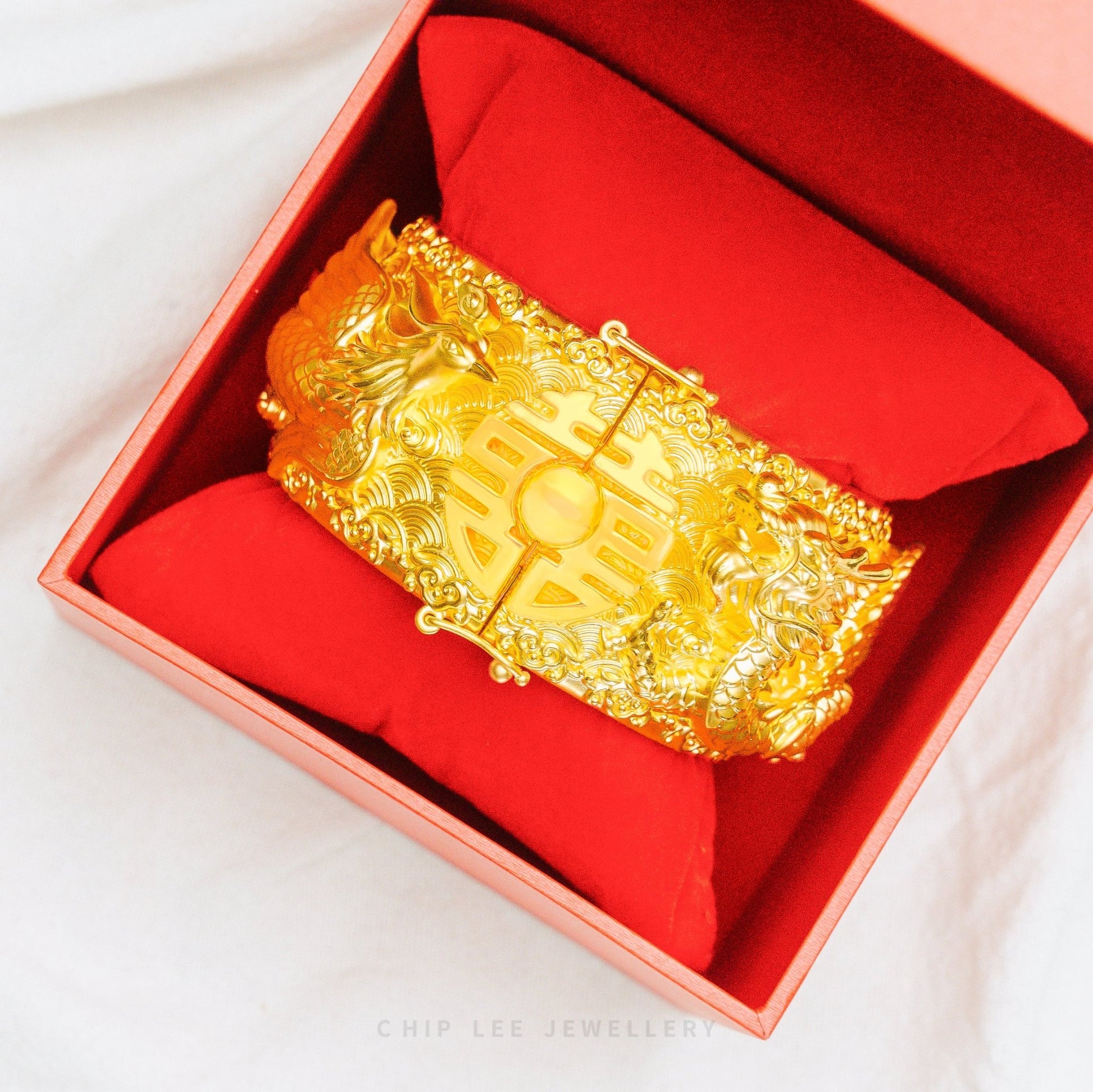999 Pure Gold Dragon Phoenix Long Feng Bangle with intricate engravings symbolising harmony, unity, and prosperity in traditional Chinese culture.