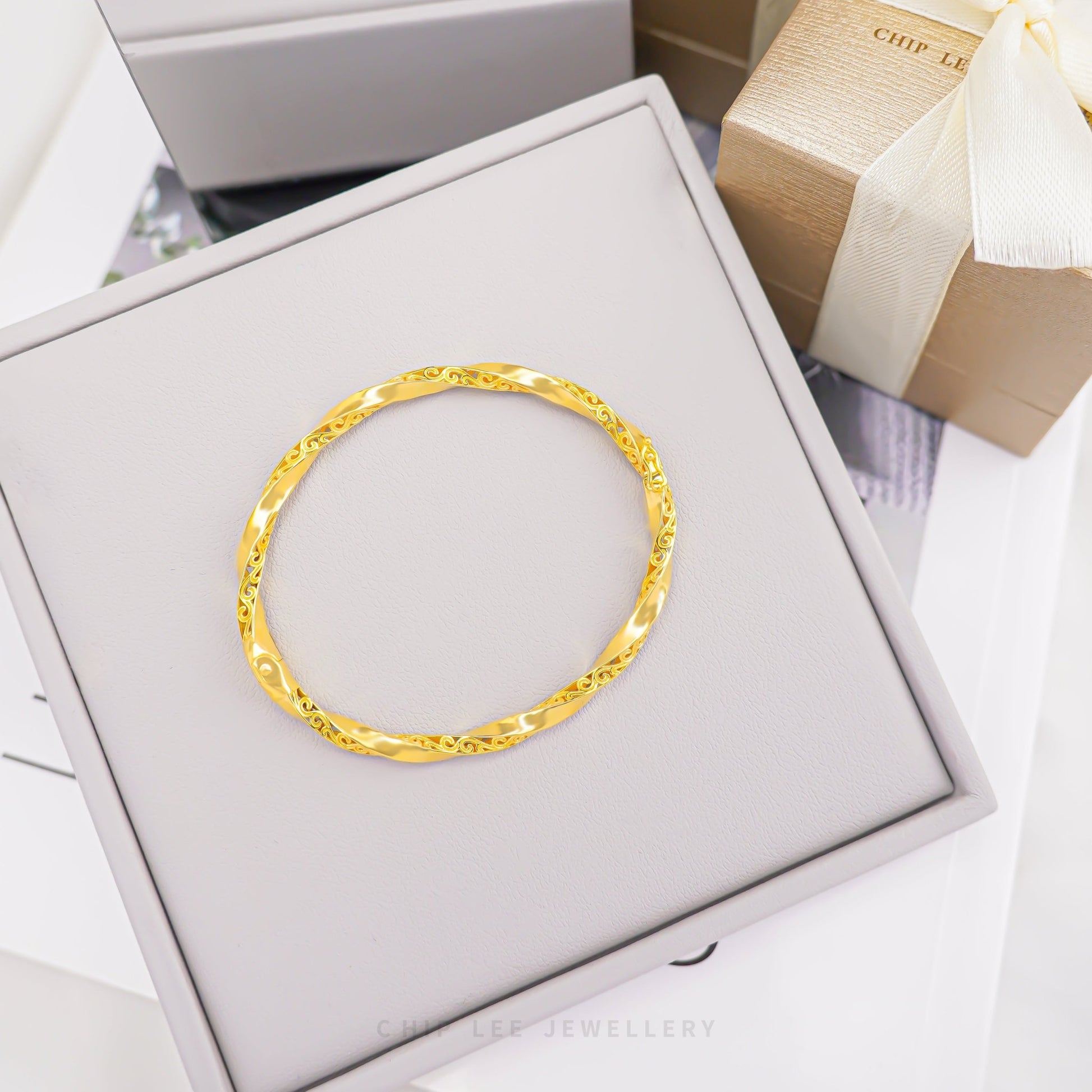 Traditional Twisted Bangle by Chip Lee Jewellery Singapore, 916/22K gold, classic twisted design, timeless craftsmanship, elegant texture, versatile accessory.