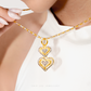 Close-up of a model wearing a 916 gold double heart pendant necklace, gently holding the chain against a white top.