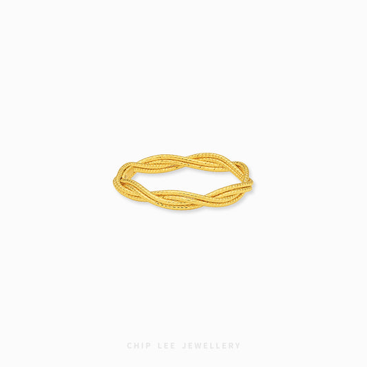 A gold twisted rope bangle bracelet by Chip Lee Jewellery, displayed on a clean white background.