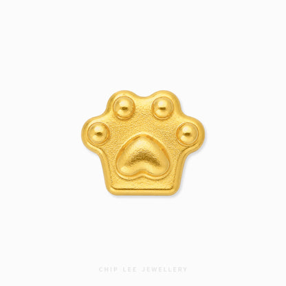 A small gold paw-print charm or pendant with a textured matte finish, centered on a plain white background. The brand name 'CHIP LEE JEWELLERY' is subtly printed in light gray text at the bottom center.