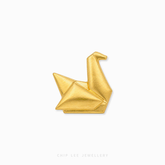 A small gold-toned folded crane pin centered on a plain white background, with the text 'CHIP LEE JEWELLERY' faintly visible at the bottom.