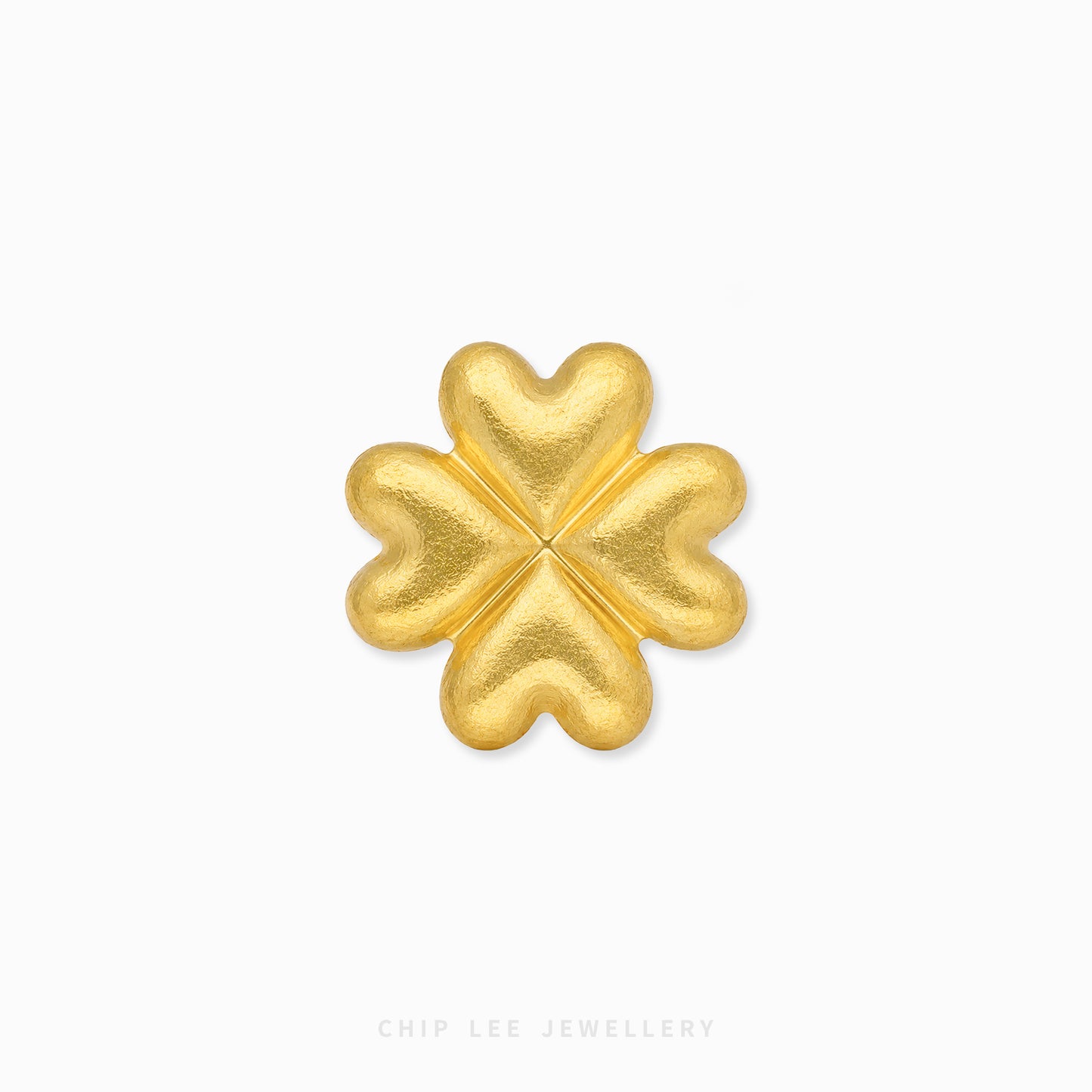 A textured gold four-leaf clover charm or brooch, centered on a clean white background with a subtle drop shadow. The brand name 'CHIP LEE JEWELLERY' is faintly visible at the bottom.