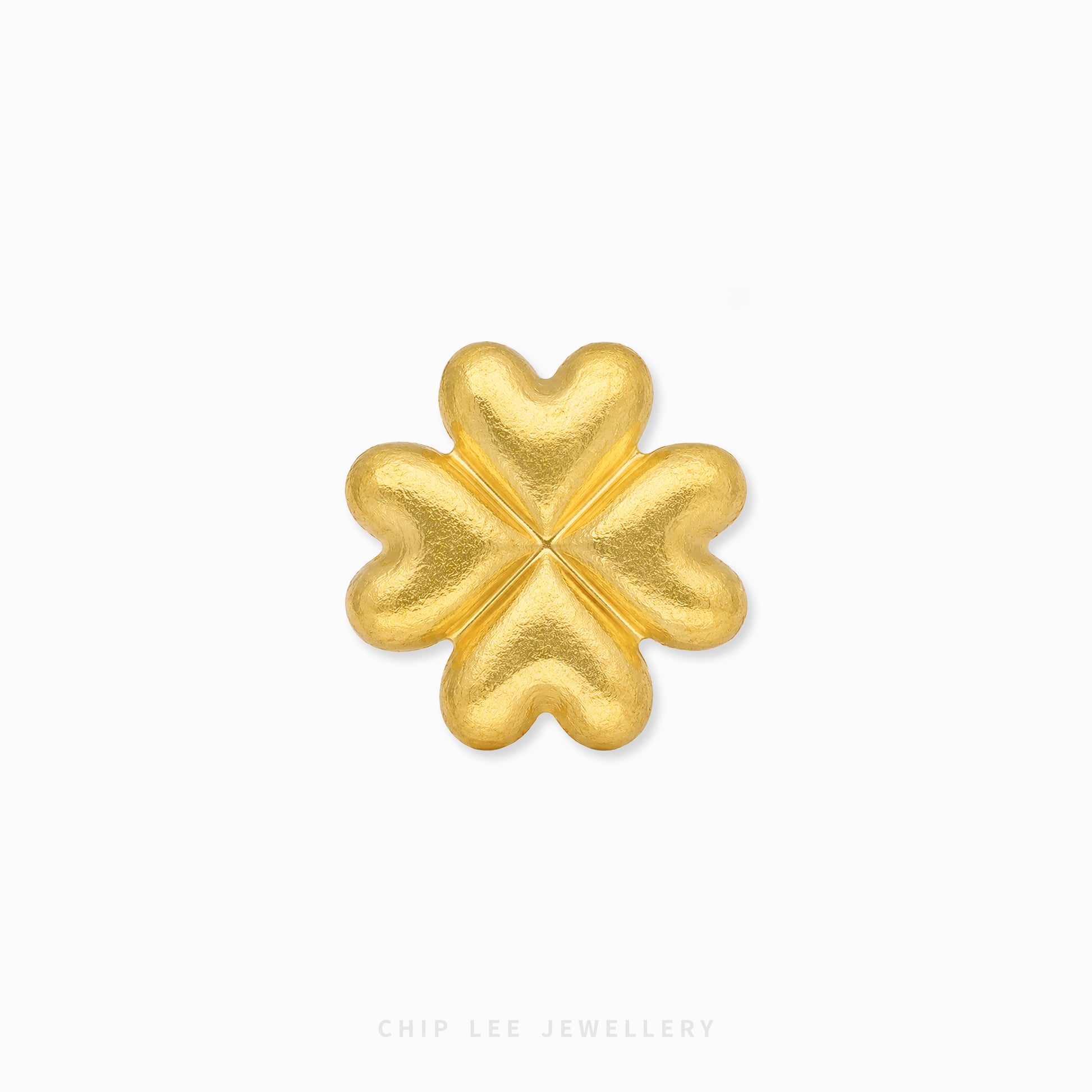 A textured gold four-leaf clover charm or brooch, centered on a clean white background with a subtle drop shadow. The brand name 'CHIP LEE JEWELLERY' is faintly visible at the bottom.