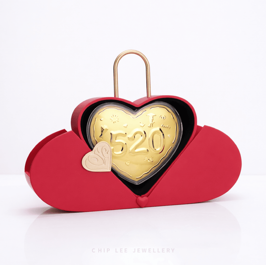 Opened red heart-shaped jewellery box revealing a 520 gold heart design inside, symbolising love and devotion, with a gold padlock-style handle for romantic gifting.
