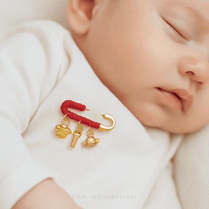 999 Pure Gold Baby Safety Brooch featuring a sleek, polished pin with delicate charm accents, symbolising protection, blessings, and elegant newborn style.
