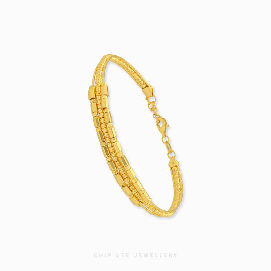 A gold multi-strand link bracelet with a textured beaded outer band and a polished central chain, shown on a light gray background with the brand name 'CHIP LEE JEWELLERY' at the bottom.