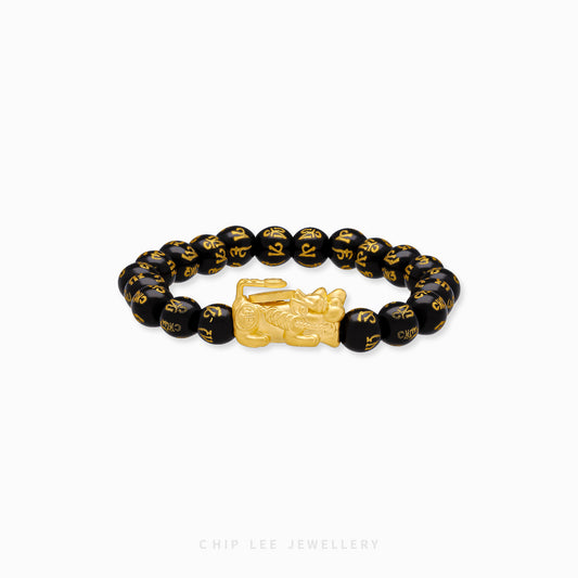 Close-up of 999 Pure Gold Black Agate Pixiu Bracelet with black agate beads and gold Pixiu charm on display.