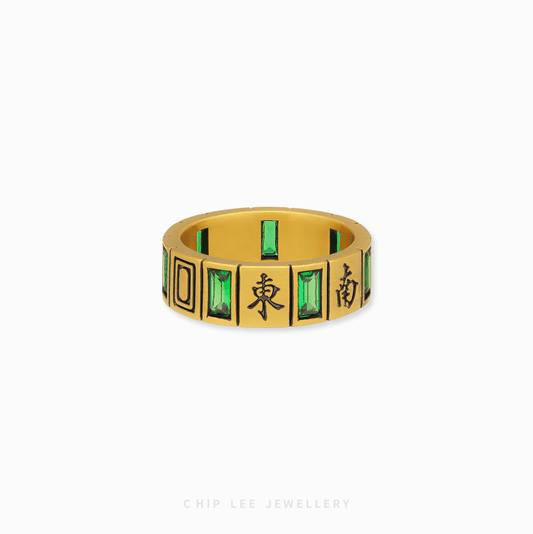 A detailed close-up of the 999 Pure Gold Black Mystic Mahjong Ring, showing the polished gold, a black mahjong tile, and a vibrant green cubic zirconia.

