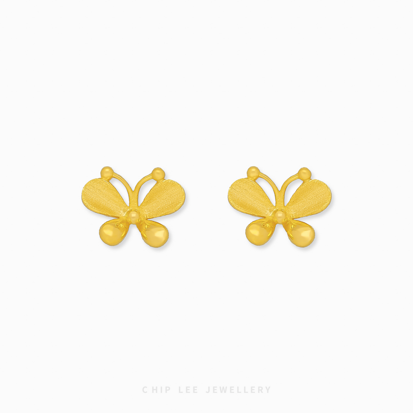 A close-up of a pair of bright yellow 999 pure gold butterfly stud earrings, displayed against a white background.