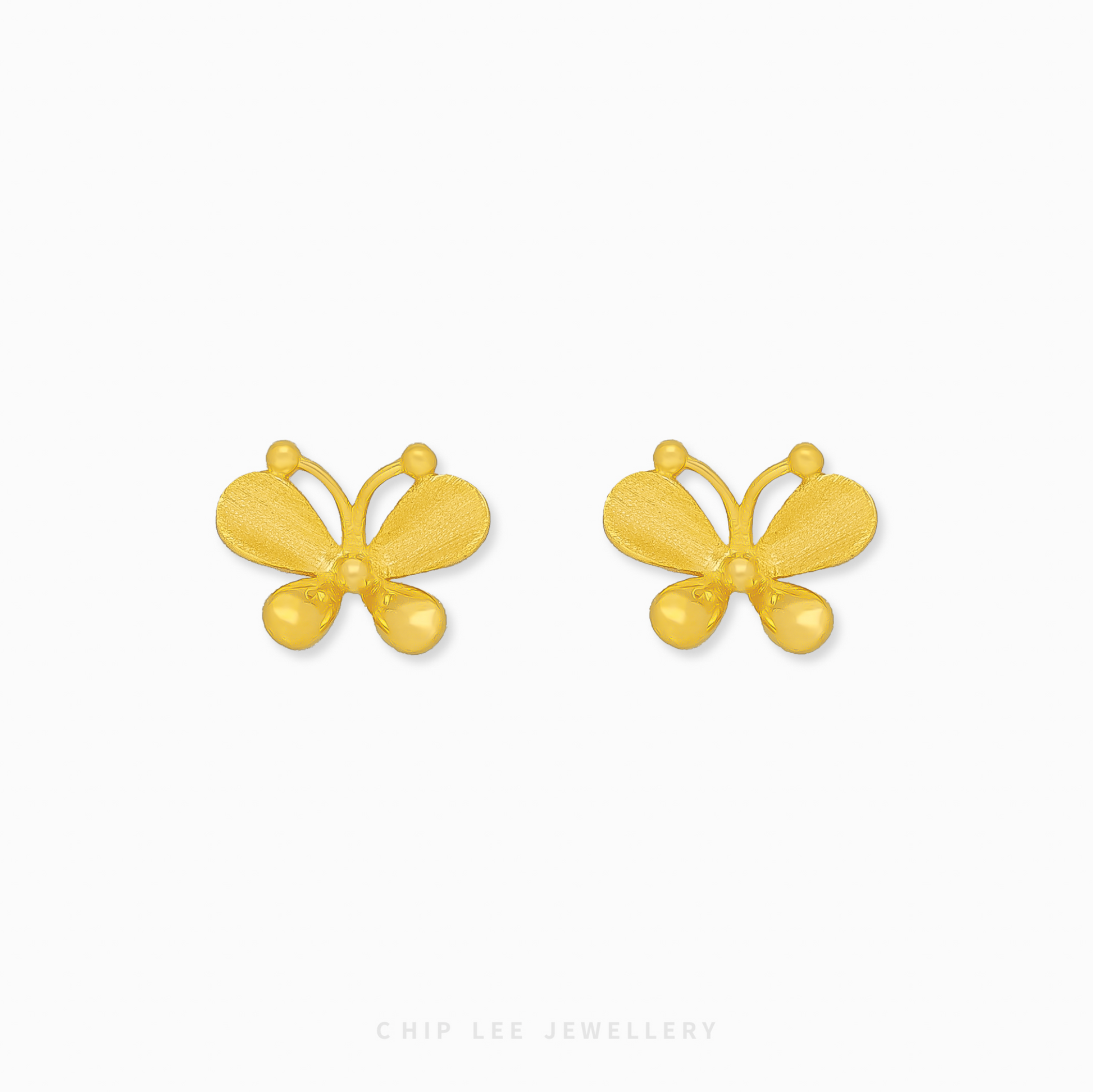 A close-up of a pair of bright yellow 999 pure gold butterfly stud earrings, displayed against a white background.