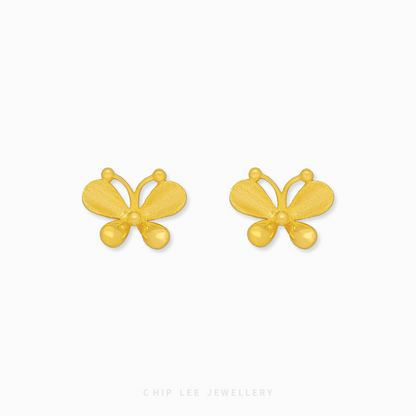 A close-up of a pair of bright yellow 999 pure gold butterfly stud earrings, displayed against a white background.