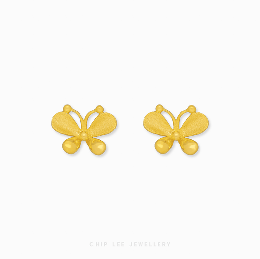 A close-up of a pair of bright yellow 999 pure gold butterfly stud earrings, displayed against a white background.