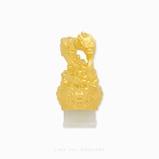999 pure gold dragon pendant embracing He Tian jade seal, symbolizing power, fortune, protection in a refined traditional jewellery design.