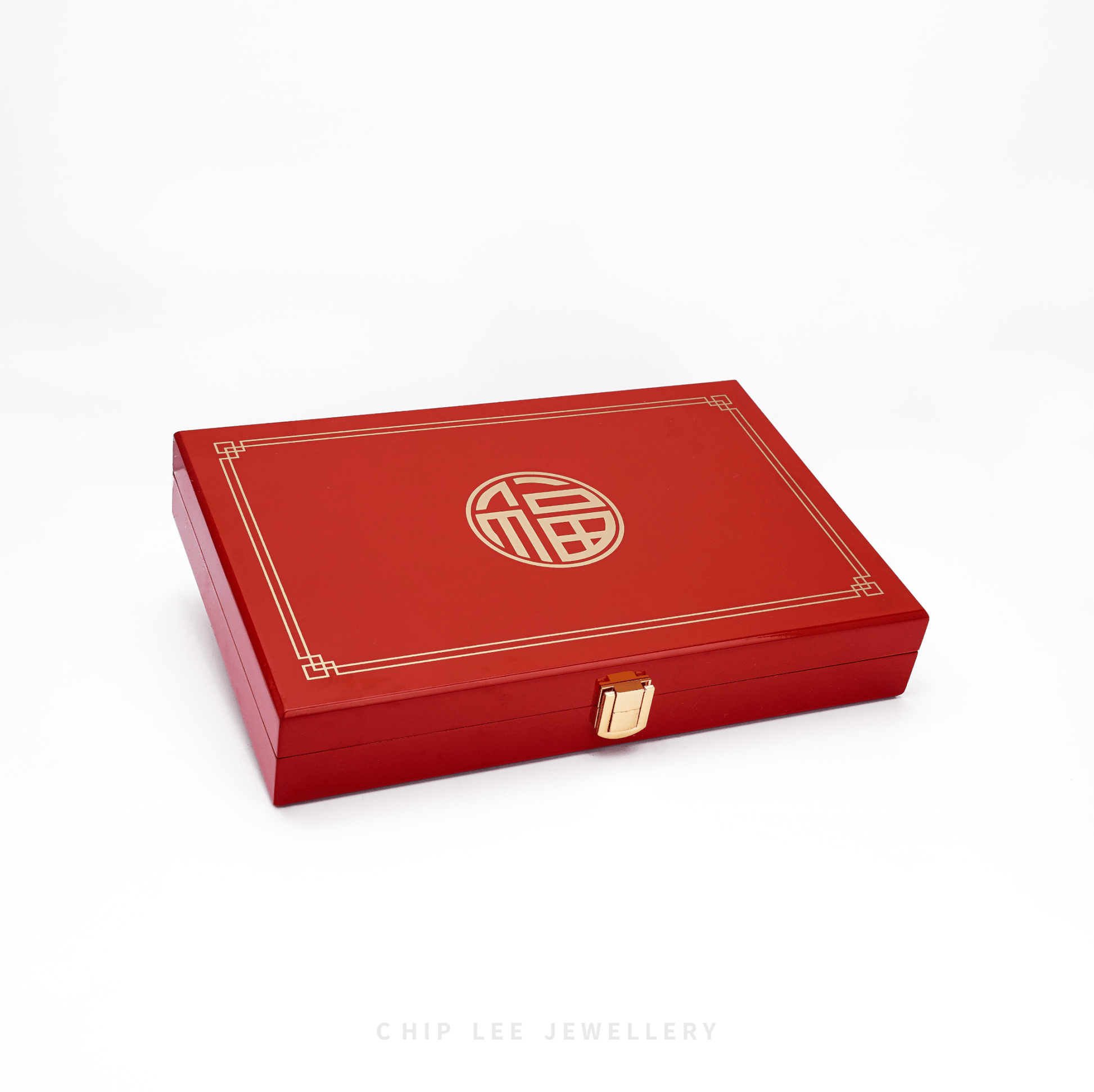 Red jewelry box with a gold emblem on a white background