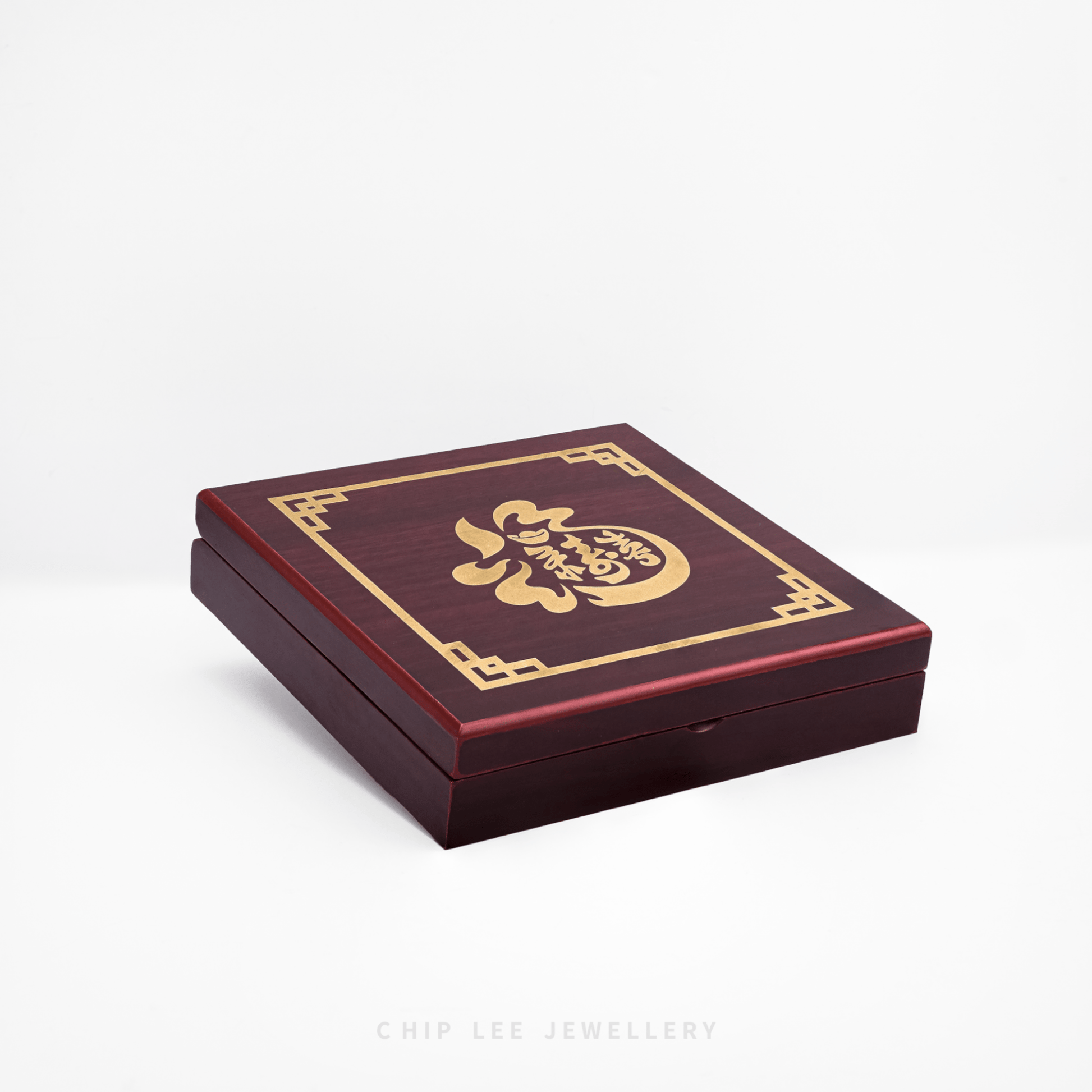 Wooden jewelry box with gold design on a white background