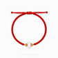A close-up of a 999 Pure Gold Adjustable Baby Bracelet, showing the detailed gold floral piece and a smooth He Tian Yu (Jade) bead.

