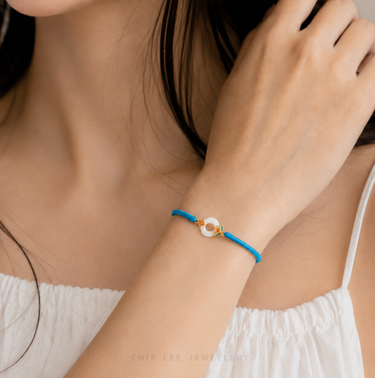 Blue bracelet with a colorful clasp on a white background