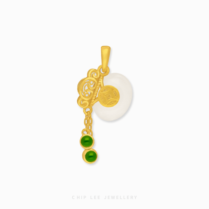 Gold pendant with green gemstones and white jade on a white background