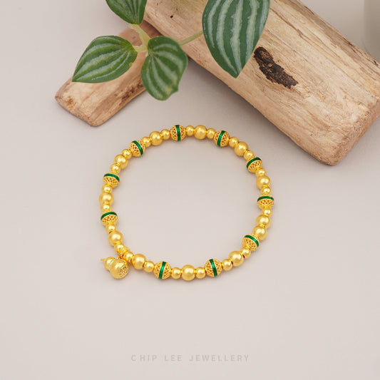 999 Pure Gold Fortune Gourd Gu Fa Jin Bracelet with symbolic gourd charm and green accents, crafted with ancient goldsmithing techniques.
