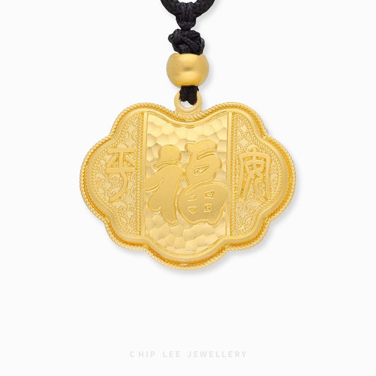 Gold pendant with intricate designs on a white background