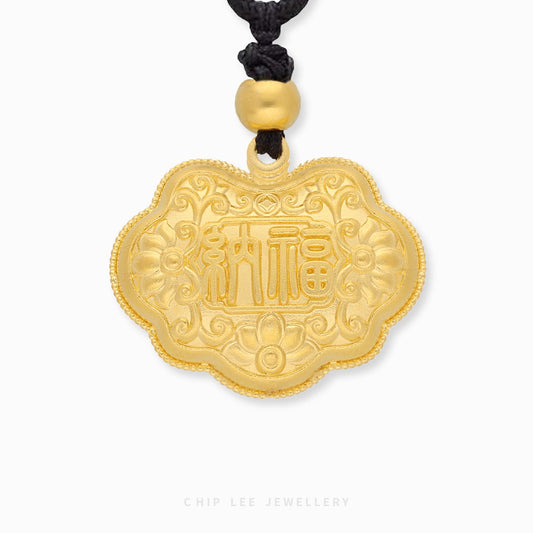 Gold pendant with Chinese characters on a white background