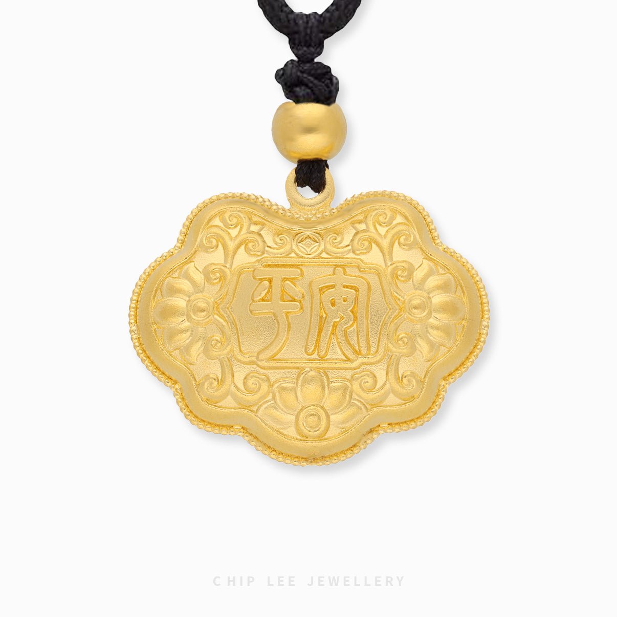 Gold pendant with intricate designs and Chinese characters on a white background