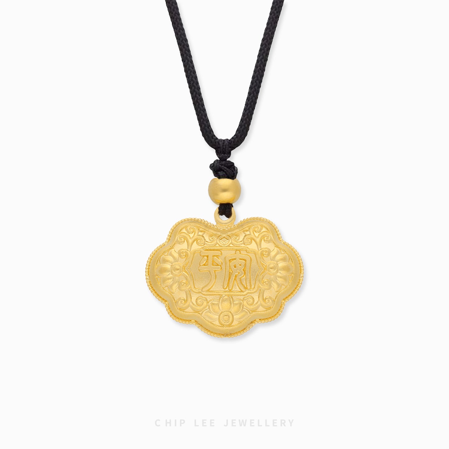 Gold pendant with intricate designs and Chinese characters on a white background