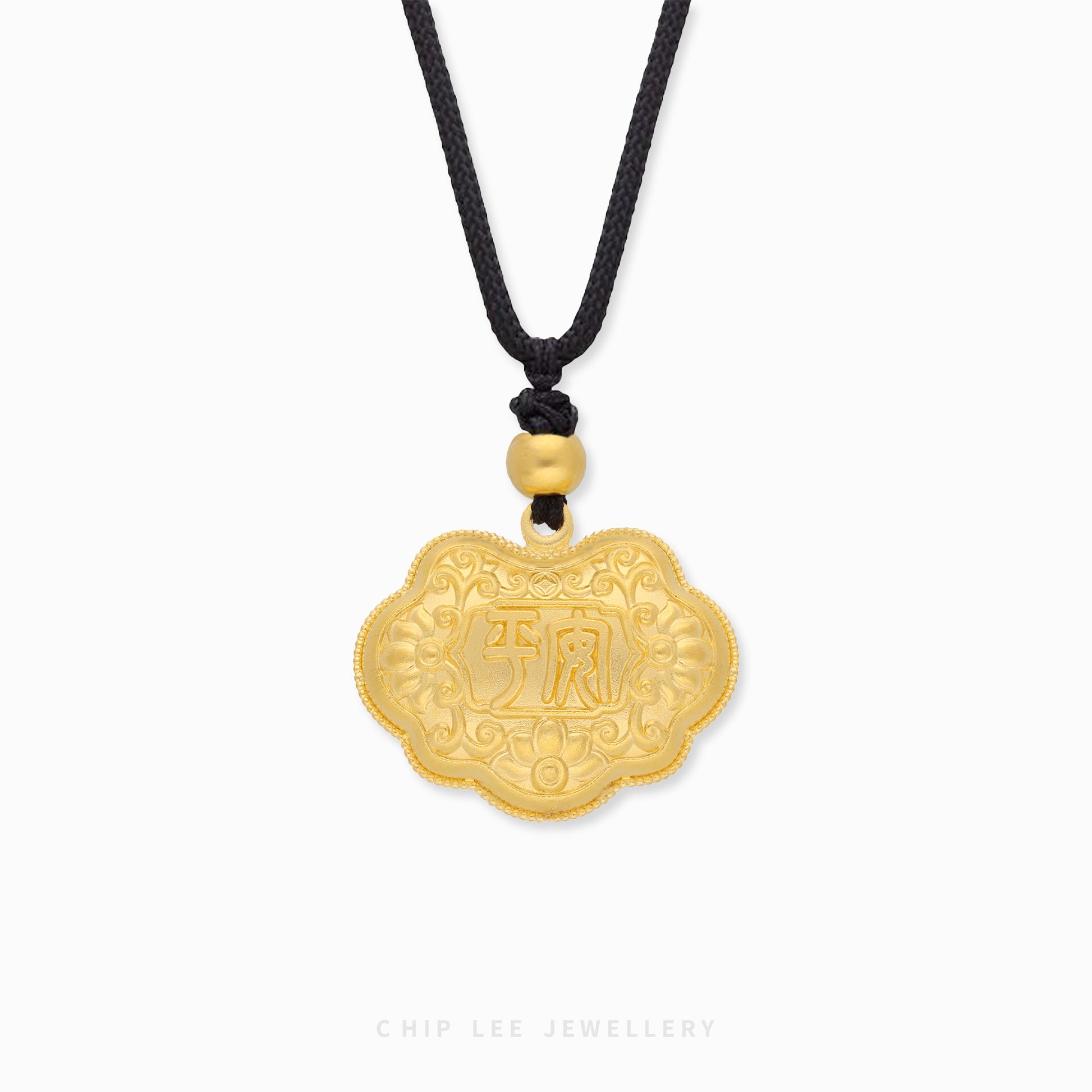 Gold pendant with intricate designs and Chinese characters on a white background