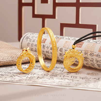 Gold jewelry set with intricate designs on a textured surface