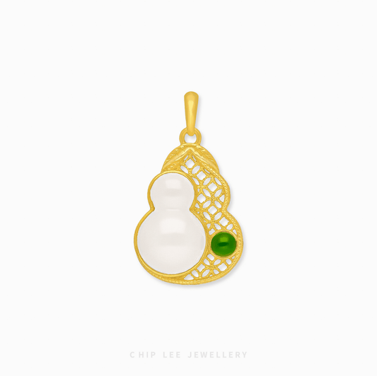 Gold pendant with a white jade and green gem on a white background