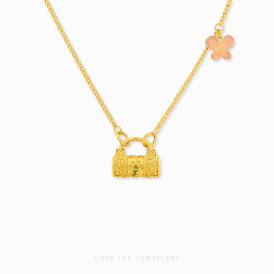 A 999 pure gold necklace with a lock and butterfly charm on a white background.