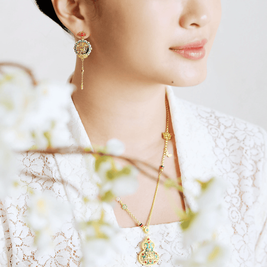999 pure gold Gu Fa Jin dangling earrings symbolising prosperity and heritage, featuring traditional texture and bold ancient craftsmanship.