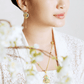999 pure gold Gu Fa Jin dangling earrings symbolising prosperity and heritage, featuring traditional texture and bold ancient craftsmanship.
