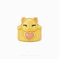 A gold cat-shaped charm with a pink glitter heart on its chest, featuring black line details for closed eyes and a smiling mouth, set against a plain white background.