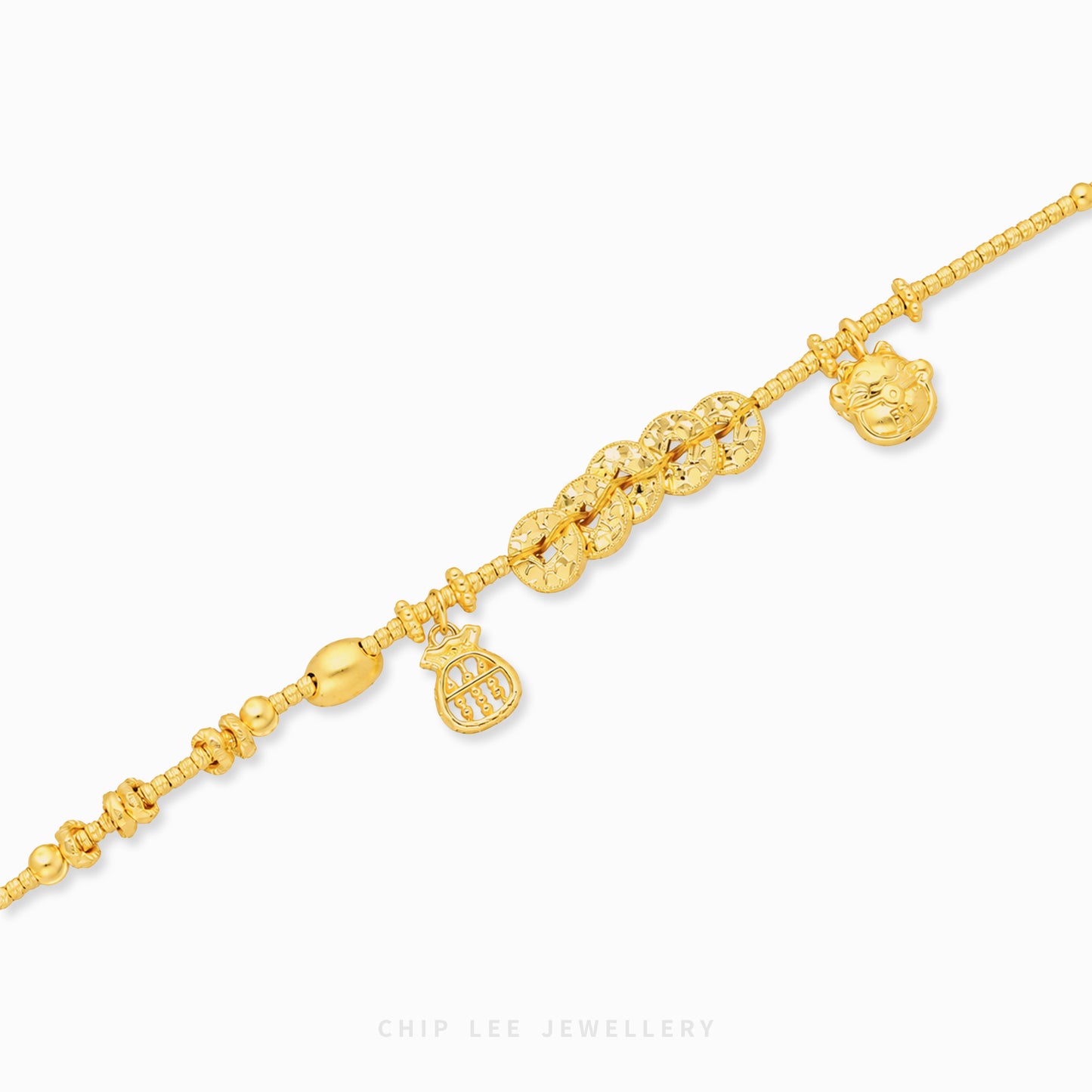 A gold chain anklet with multiple charms, including a lion head, a crown, and a cluster of small round stones, displayed on a clean white background with a Chip Lee Jewellery watermark.