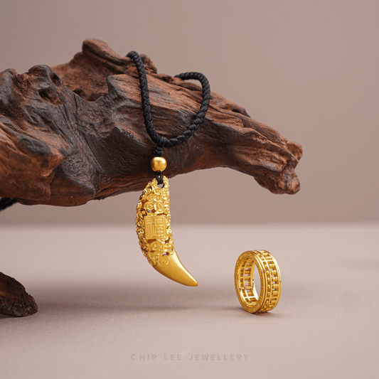 999 pure gold necklace and ring on a wooden surface.