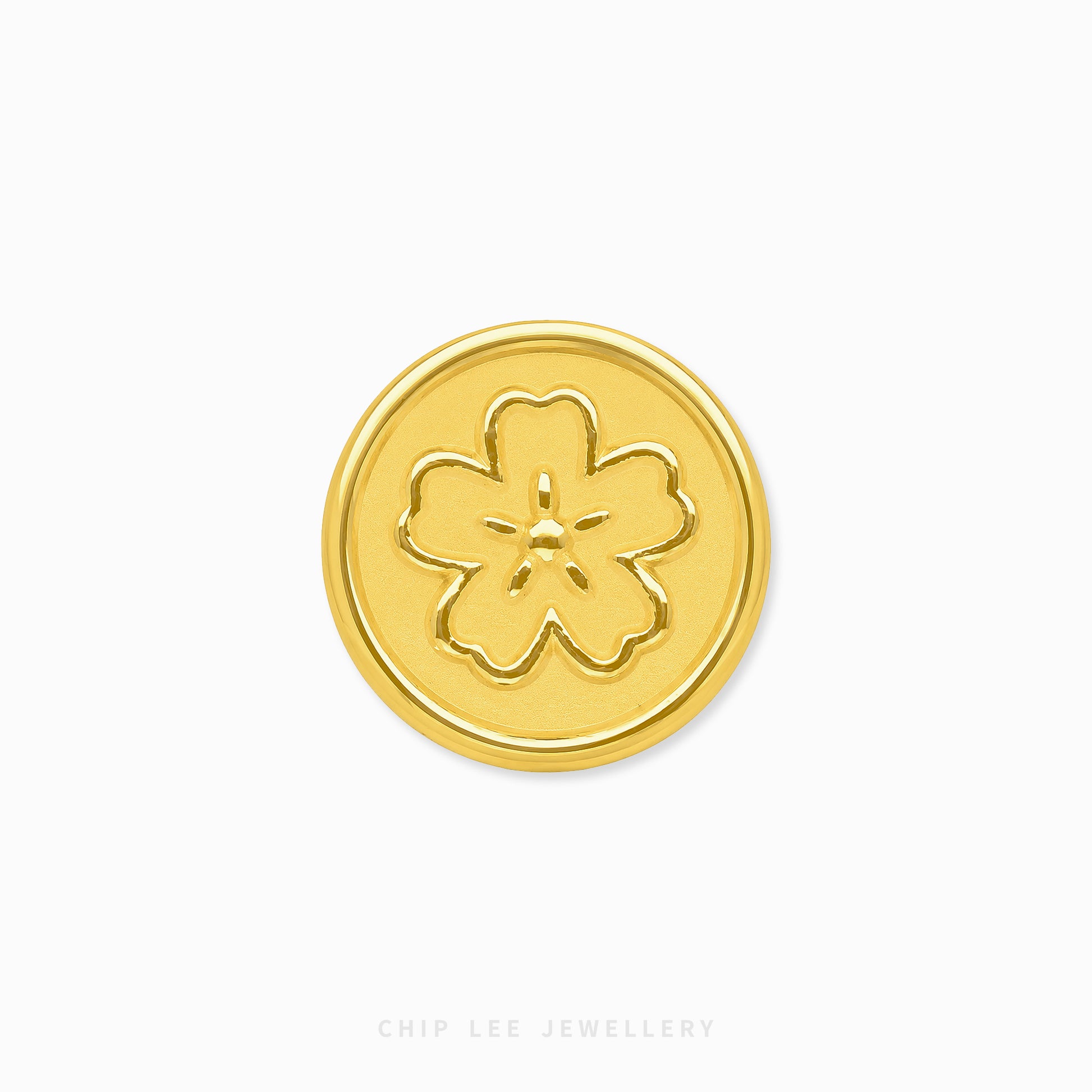 A round gold button with an embossed five-petal flower motif, centered on a plain white background with 'CHIP LEE JEWELLERY' printed faintly at the bottom.