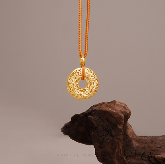 Close-up of 999 Pure Gold Serenity Lotus Necklace in textured gold, lotus motif. Crafted in ancient goldsmithing techniques.