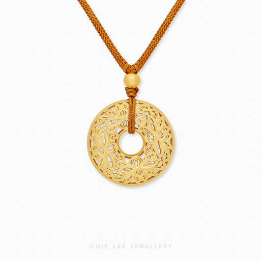 Close-up of 999 Pure Gold Serenity Lotus Necklace in textured gold, lotus motif. Crafted in ancient goldsmithing techniques.