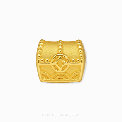 A gold treasure chest charm with embossed details and a central diamond motif, shown on a clean white background with the brand name 'CHIP LEE JEWELLERY' at the bottom.