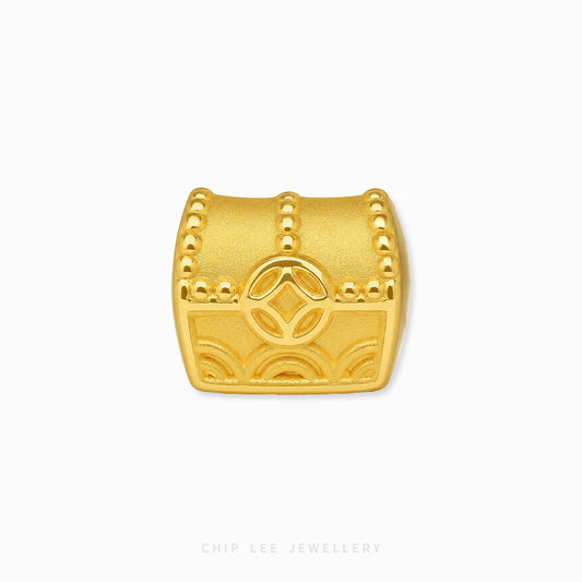 A gold treasure chest charm with embossed details and a central diamond motif, shown on a clean white background with the brand name 'CHIP LEE JEWELLERY' at the bottom.