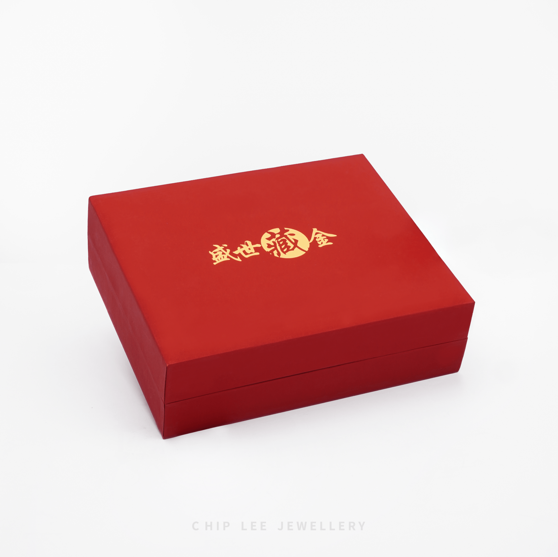 Red jewelry box with gold text on a white background